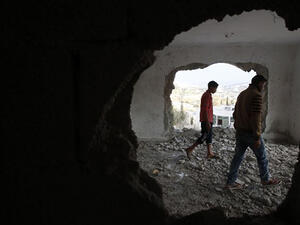 A relative and the brother (R) of late Mohammed Nasser Tarayrah, a Palestinian attacker who stabbed to death an Israeli teen in a Jewish settlement, inspect Tarayrah's home after Israeli army partially destroyed it. (AFP/File)