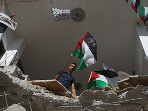 Palestinian flag are seen placed on the rubble of a house belonging to a Palestinian man who carried out a knife attack in Tel Aviv. (AFP/File)