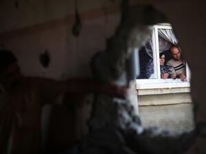 Palestinians check the damage in their house after it was hit by Israeli tank fire on September 6, 2016 in Beit Hanoun in the northern Gaza Strip. (AFP/Mohammed Abed)
