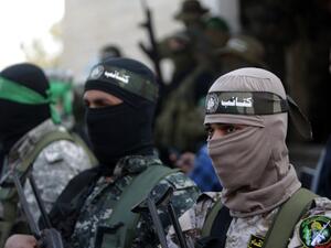 Palestinian members of the Qassam Brigades, the armed wing of Hamas mourn during the funeral of Ahmed al-Zahar in the village of Al-Moghraga in the Gaza Strip on February 3, 2016. (AFP/Mahmud Hams)