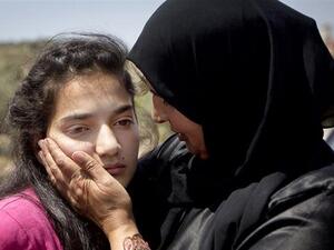 Palestinian 12-year-old Dima al-Wawi, imprisoned by Israel for allegedly attempting to carry out a stabbing attack, is greeted by her mother Sabha al-Wawi and her father Ismail al-Wawi after her release from an Israeli prison, at Jabara checkpoint near the West Bank town of Tulkarem on April 24, 2016. (Twitter/Press TV)