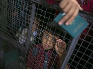 A Palestinian child looks through a barrier as he waits at the Rafah border crossing with Egypt, in the southern Gaza Strip, after it was opened for two days by Egyptian authorities, on May 11, 2016. (AFP/Said Khatib)