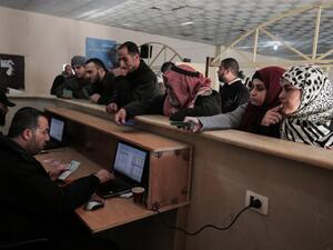 Palestinians wait for travel permits to cross into Egypt through the Rafah border crossing after it was opened by Egyptian authorities for humanitarian cases, in Rafah in the southern Gaza Strip December 10, 2016. (AFP/Said Khatib)