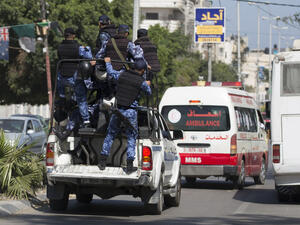 Hamas police escort an ambulance carrying the bodies of three men executed on 6 April 2017 in Gaza City. (AFP) 