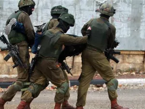Israeli soldiers carry a Palestinian after he was detained during clashes in the West Bank city of Bethlehem. (AFP/ File)