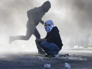 Palestinian protesters clash with Israeli troops near an Israeli checkpoint in the West Bank city of Ramallah on December 8, 2017 (Abbas Momani/AFP)
