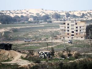 This photo taken on February 9, 2017 shows a picture taken from the southern Gaza Strip of Egyptian soldiers patrolling the Egyptian side of the Rafah border crossing. (AFP/Said Khatib)