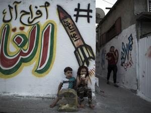 Palestinian children play with chicks in the streets in Jabalia refugee camp, in the northern Gaza Strip, on May 14, 2017 one day before the marking of the 69th anniversary of the "Nakba." (AFP/Mahmud Hams)