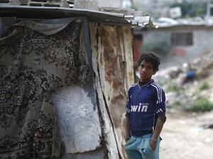 A Palestinian boy stands outside his home in Gaza City, on April 27, 2017. (AFP/Mohammed Abed)