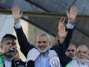 This file photo taken on August 27, 2014 shows Hamas leader in the Gaza Strip Ismail Haniya (C) waving to the crowd during a rally in Gaza City following a deal hailed by Israel and the Islamist movement as 'victory' in the 50-day war. (AFP/Mohammed Abed)
