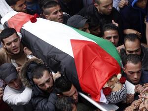 Mourners carry the body of a Palestinian citizen at a funeral in Palestine. (AFP)