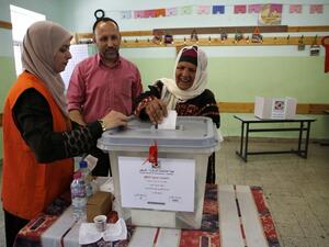 A Palestinian woman casts her ballot during the municipal elections in the West Bank city of Ramallah on May 13, 2017. (AFP/Abbas Momani)