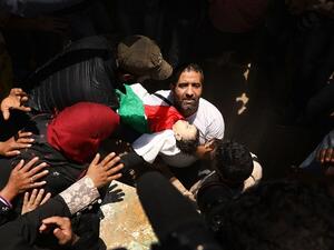 The body of eight-month-old Leila Anwar Ghandoor, who died in hospital, Tuesday morning, from tear gas inhalation, is placed into a grave, May 15, 2018 in Gaza City, Gaza. Anwar was with a relative during the clashes. (AFP/ File Photo)