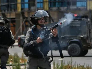 An Israeli border guard fires a teargas canister towards Palestinian protesters during clashes near the settlement of Beit El, near the occupied West Bank city of Ramallah. (AFP/File)