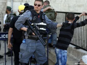 Israeli forces stop and search a Palestinian boy at the entrance of Damascus Gate, outside Jerusalem's Old City. ( AFP / Ahmad Gharabli)