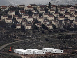 New prefabricated homes are seen under construction in the West Bank between the Israeli outpost of Amona and the settlement of Ofra (background), north of Ramallah, on January 31, 2017. (AFP/Thomas Coex)