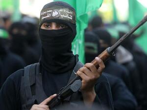 Palestinian militants of the Ezzedine al-Qassam Brigades, the Hamas' armed wing, take part in a rally in Gaza City. (photo credit: MAHMUD HAMS / AFP)