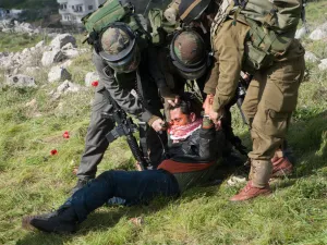 Israeli soldiers pepper spray a Palestinian as they crackdown on protest over land belonging to the West Bank. (Shutterstock/ File Photo)