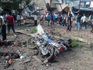 People gather around the site of an explosion at a restaurant in the central Indian state of Madhya Pradesh on September 12, 2015, where 88 people were killed and 100 injured (AFP)
