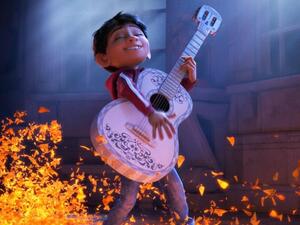 Coco plays the guitar. (Walt Disney)