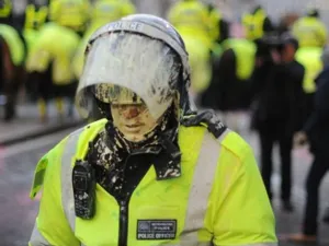 A British riot policeman is covered in paint during student demonstrations in London, on December 9, 2010. Angry demonstrators clashed with police in a student protest outside parliament Thursday as the coalition government faced its biggest test yet in a vote on proposals to triple university tuition fees