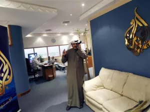 Al-Jazeera's bureau chief in Kuwait Saad al-Saedi talks on his mobile phone at the channel's office in Kuwait City on December 13, 2010