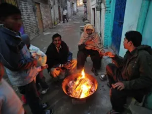 Islamabad : Pakistani Christian warm themselves around a fire in the slum area of Islamabad
