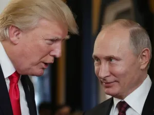 US President Donald Trump chats with Russia's President Vladimir Putin as they attend the APEC Economic Leaders' Meeting (Mikhail Klimentyev/AFP)