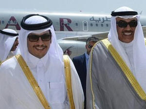 A handout picture released by the Emiri Diwan in Kuwait on July 3, 2017, shows Kuwaiti Foreign Minister Sheikh Sabah al-Khaled al-Sabah (R) receiving Qatari Foreign Minister Sheikh Mohammad Bin Abdulrahman al-Thani at Kuwait International Airport. (AFP)
