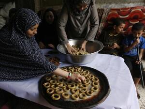 Palestinians celebrate the Eid by making sweet pastries.