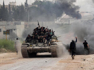 Fighters from a coalition of Islamist forces celebrate on after taking the al-Mastumah base in the Syrian city of Idlib . AFP/ File)