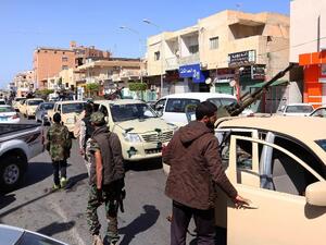 Members of Libyan opposition group Libyan Dawn wait at a checkpoint in Sabratha, after fierce clashes with Daesh militants. (AFP/Mahmud Turkia)