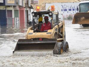 A Saudi worker clears a flooded street in Riyadh. (AFP/Fayez Nureldine)