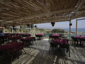 Empty tables are seen in a restaurant on the Beirut's corniche, with a sea view of the capital's landmark Pigeon's Rock, which was once crowded by tourists mainly from the Gulf states at this time of the year (Source: AFP/JOSEPH EID)