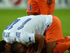 Two Muslim soccer players in France pray during a match (AFP)