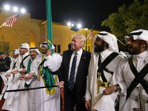US President Donald Trump joins dancers with swords at a welcome ceremony ahead of a banquet at the Murabba Palace in Riyadh on May 20, 2017. (AFP/Mandel Ngan)