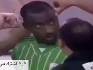 A screenshot from a video showing a Saudi Arabian soccer player getting his hair cut during a game because his hair style was deemed un-Islamic. 