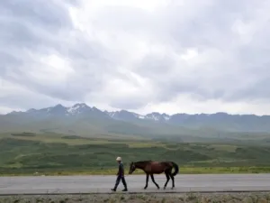 A man walks along a road at a pasture in Kazakhstan situated along the ancient Silk Road. (AFP/File)
