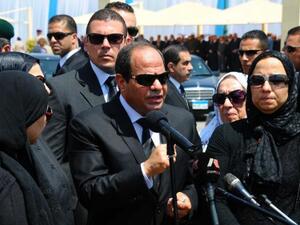 President al Sisi with the family of Hisham Barakat, the recently assassinated chief prosecutor (AFP/file)