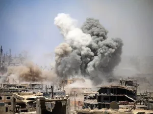 Smoke rises from buildings following a reported air strike on a rebel-held area in the southern Syrian city of Daraa. (AFP)
