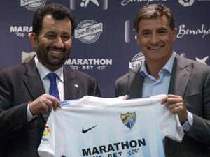 Malaga's new coach Jose Miguel Gonzalez Martin del Campo aka Michel (R) poses with Malaga CF's chairman Sheikh Abdallah Ben Nasser Al-Thani during his official presentation at the Rosaleda stadium in Malaga, on March 8, 2017.
JORGE GUERRERO / AFP