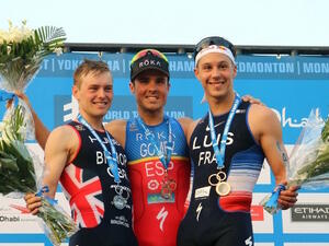 Second place winner Thomas Bishop of England (L), Spanish athlete Javier Gomez Noya (C) of Spain, winner of the ITU World Triathlon, and third place winer Vincent Luis of France, pose on stage at the Yas Marina Circuit in Abu Dhabi after competing on March 4, 2017.
NEZAR BALOUT / AFP