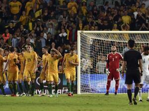 Australian players (L) celebrate their third goal as Jordan goalkeeper Amer Shafi (C) looks on during the World Cup Asian qualifier football match between Australia and Jordan in Sydney on March 29, 2016.
SAEED KHAN / AFP