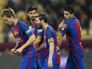 Barcelona's Luis Suarez (R), Linonal Messi (C), Ivan Rakitic (L) and André Gomes (2nd L) celebrate after a goal during a friendly football match between FC Barcelona and Saudi Arabia's Al-Ahli FC on Dec 13, 2016 in the Qatari capital Doha. Barcelona played Al-Ahli in a friendly in Doha, the Spanish club's last major obligation of its four year shirt sponsorship deal with Qatar Airways.