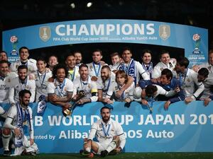 Real Madrid players pose with their trophy after winning the Club World Cup football final match against Kashima Antlers of Japan at Yokohama International stadium in Yokohama on December 18, 2016.
Behrouz MEHRI / AFP