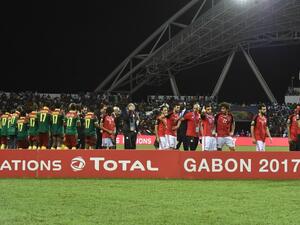 The Egyptian football team walks off the pitch as the Cameroon team wait to receive the winner's trophy after beating Egypt 2-1 in the 2017 Africa Cup of Nations final football match between Egypt and Cameroon at the Stade de l'Amitie Sino-Gabonaise in Libreville on February 5, 2017.
ISSOUF SANOGO / AFP