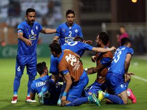 Iranian club Esteghlal's players celebrate after scoring a goal against Saudi club Al-Hilal during their Asian Champions League football match on February 20, 2018 at al-Seeb stadium in Muscat.
MOHAMMED MAHJOUB / AFP