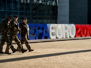 Soldiers walk past giant letters reading "UEFA EURO 2016" as they patrol on February 3, 2016, in Lille, northern France, where some of the Euro 2016 football matches will take place. The upcoming UEFA Euro 2016 European football championship will take place in France from June 10 to July 10, 2016.
PHILIPPE HUGUEN / AFP