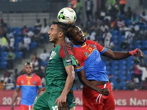 Democratic Republic of the Congo's midfielder Merveille Bokadi (R) heads the ball with Morocco's forward Aziz Bouhaddouz during the 2017 Africa Cup of Nations group C football match between DR Congo and Morocco in Oyem on January 16, 2017.
ISSOUF SANOGO / AFP