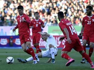 Palestinian forward Tamer Seyman (L) vies for the ball with Algerian Zinedine Ferhat (C) during a friendly match between the Palestinian and Algerian Olympic football teams at the Stade du 5 Juillet 1962 stadium in Algiers on February 17, 2016. 